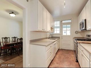 Main level kitchen. Rear door leads to outdoor deck. Gas oven, built-in microwave, dishwasher.