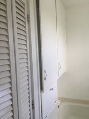 Closets across from vanity in the bathroom.