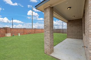 The covered patio is perfect for an outdoor living space, bbq pit and more.