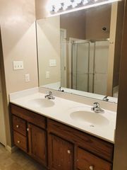 Master Bath with double vanity, soaking tub, walk in shower and linen closet.