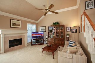 High ceilings and gas log fireplace makes the den the perfect family gathering place .