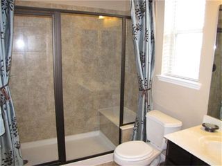 The 4th Bedroom Downstairs Has This Full Bathroom In It. A Really Spacious Walk-In Shower W Seat and Upgraded ORB Framed Glass