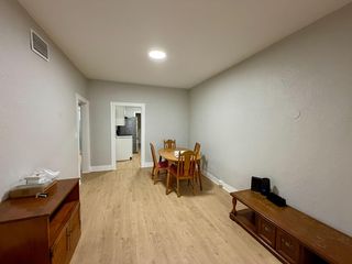 Dedicated dining area with wood-look flooring and space for a table set, conveniently positioned next to the kitchen.