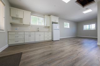 Shared great room with refrigerator, sink and cabinets