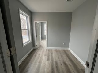 Middle room between rear bedroom and hallway. Perfect for an office or play area.