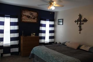 Master bedroom off from the kitchen. Large enough for a king size bed. Carpet floor. Ceiling fan.