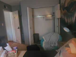 Bedroom with an open closet, wall hooks, and space for a bed plus seatingeasy layout for everyday living.