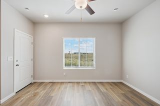 The family room is spacious with a ceiling fan.