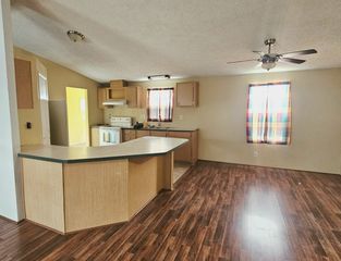 Living Room Opens to Kitchen w/ Breakfast Bar