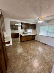 Peninsula breakfast bar and dinette space. In the background, there is a laundry room and a half bathroom.