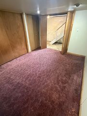 View from inside basement "bonus room" to stairs access to kitchen.