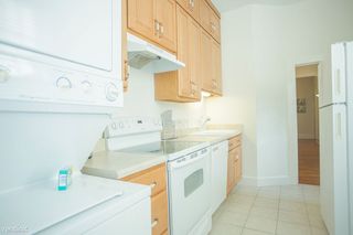 The stacking washer/dryer can be found in the kitchen.